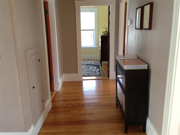 149 Market Street Amesbury, MA 01913 - Photo 10 of 23 a view of a hallway with wooden floor and staircase