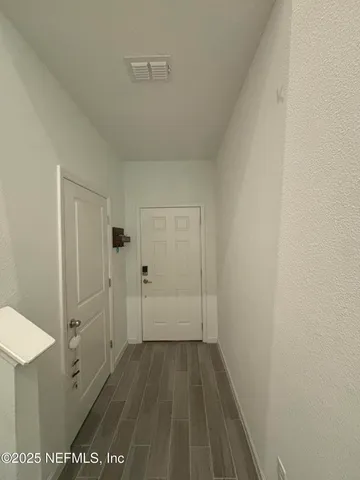 a bedroom with a bed and a flat tv screen on dresser