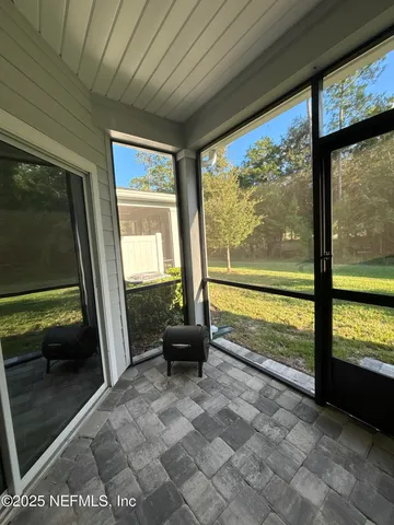 a living room with furniture a fireplace and a flat tv screen next to a window