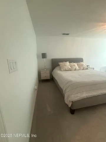 a view of a patio with dining table and chairs under an umbrella