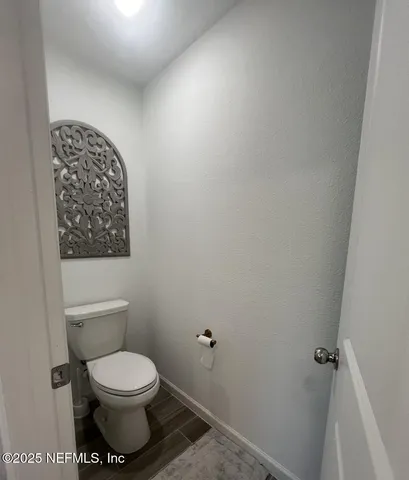 a kitchen with a table chairs and flat screen tv
