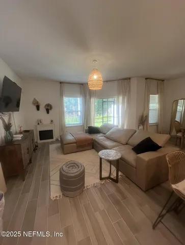 a view of a hallway with wooden floor and closet