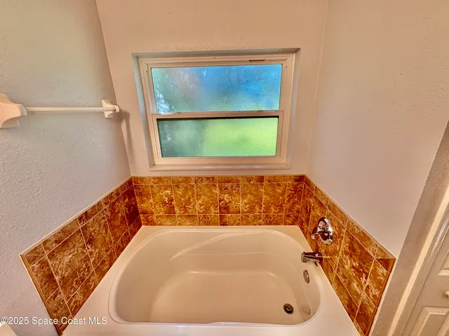 a bathroom with a tub and shower
