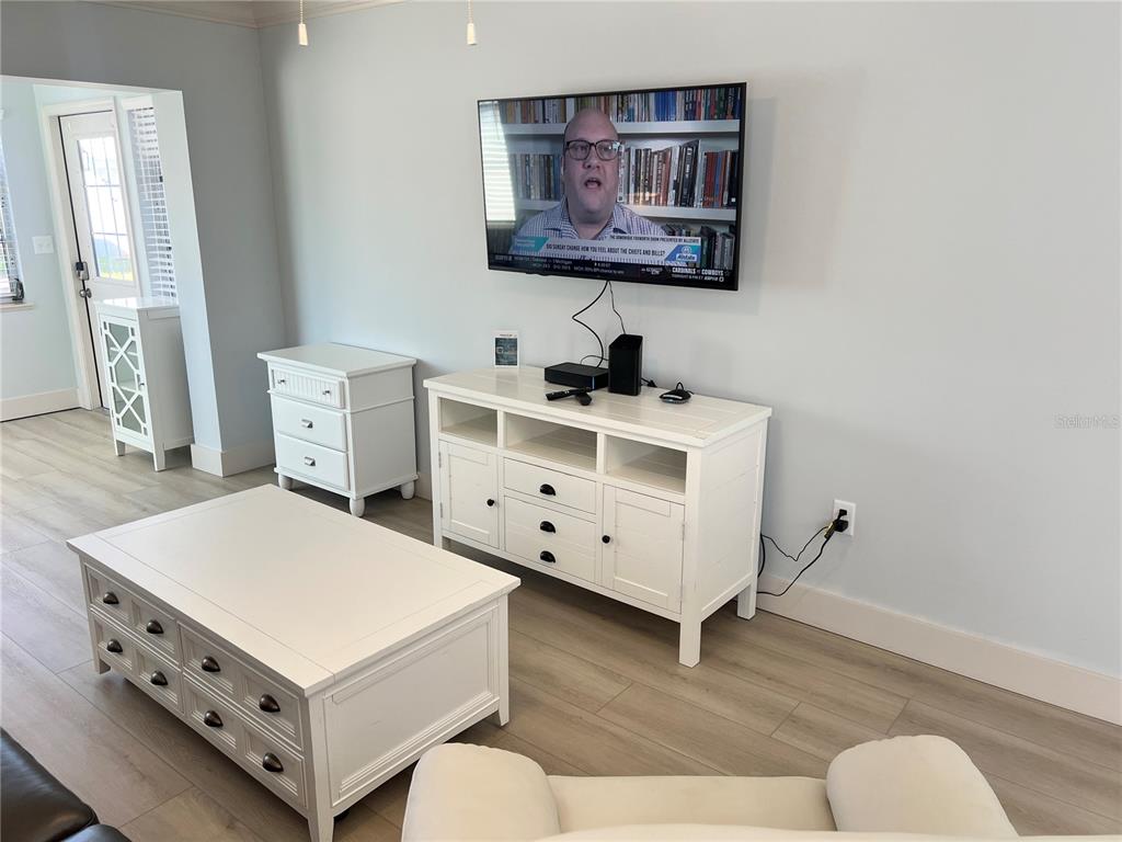 6020 Midnight Pass Road, Unit 32 Sarasota, FL 34242 - Photo 3 of 13 a room with furniture and wooden floor