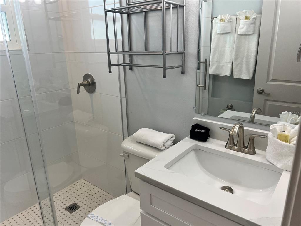 6020 Midnight Pass Road, Unit 32 Sarasota, FL 34242 - Photo 8 of 13 a bathroom with a sink and toilet