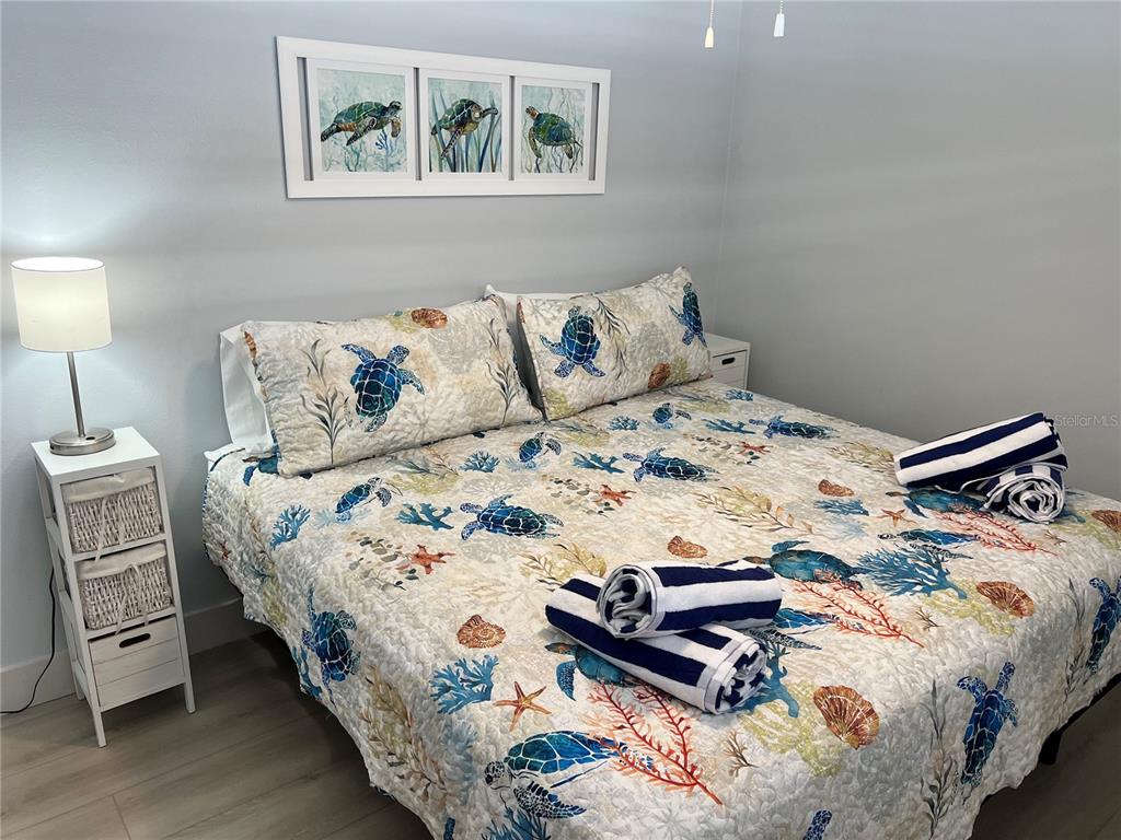 6020 Midnight Pass Road, Unit 32 Sarasota, FL 34242 - Photo 10 of 13 a bedroom with a bed and a night stand