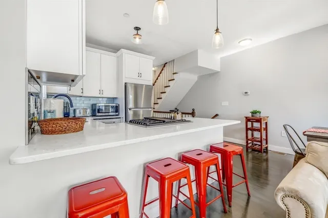 a kitchen with stainless steel appliances granite countertop a refrigerator and a sink