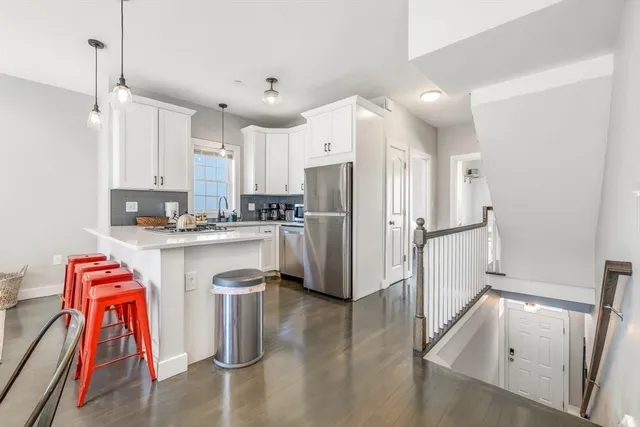 a view of kitchen with sink and wooden floor