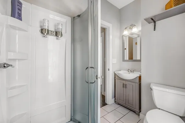 a bathroom with a sink toilet and mirror
