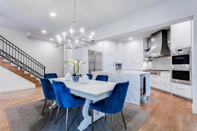 a view of a dining room with furniture wooden floor and chandelier