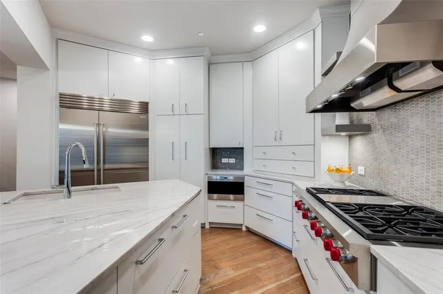 a kitchen with stainless steel appliances granite countertop a stove and a refrigerator
