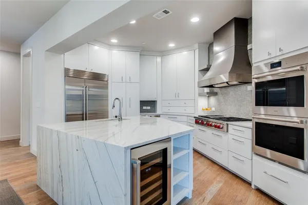 a kitchen with stainless steel appliances granite countertop a stove and a refrigerator