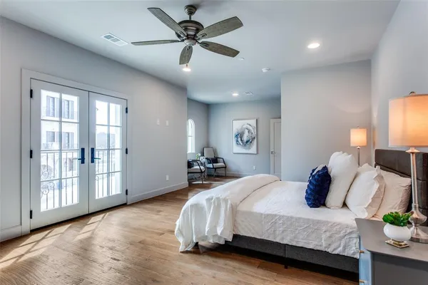 a bedroom with a bed and wooden floor