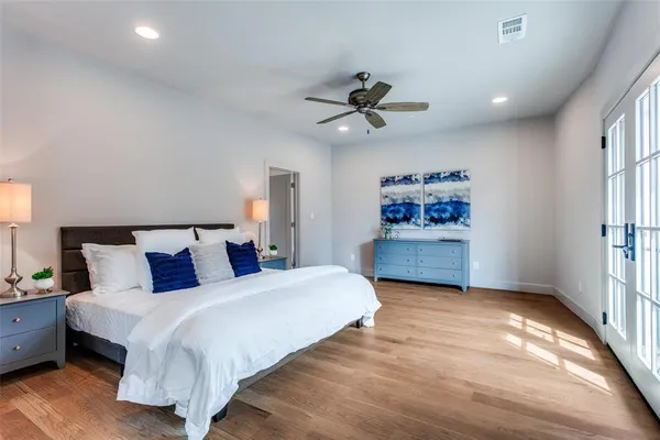 a bedroom with a large bed and a chandelier