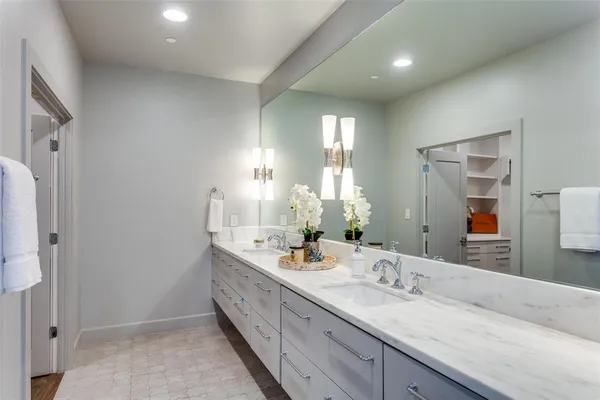 a bathroom with double sink and a mirror