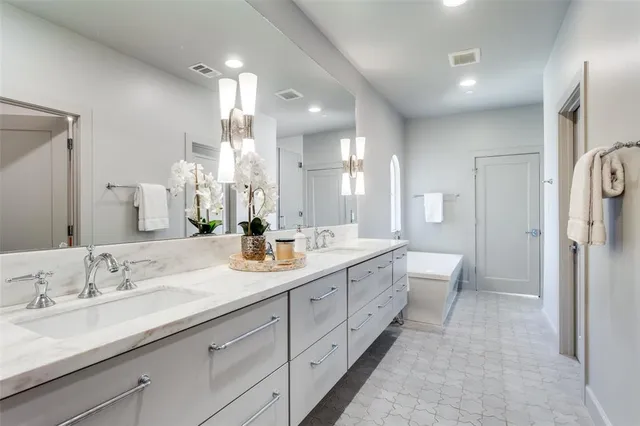 a spacious bathroom with a double vanity sink mirror double and shower