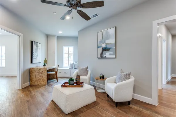 a living room with furniture and a wooden floor