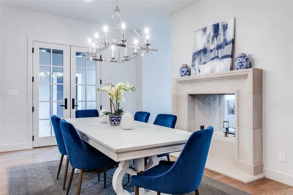 a view of a dining room with furniture and chandelier