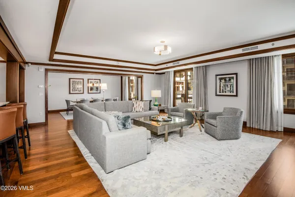 a living room with furniture and wooden floor
