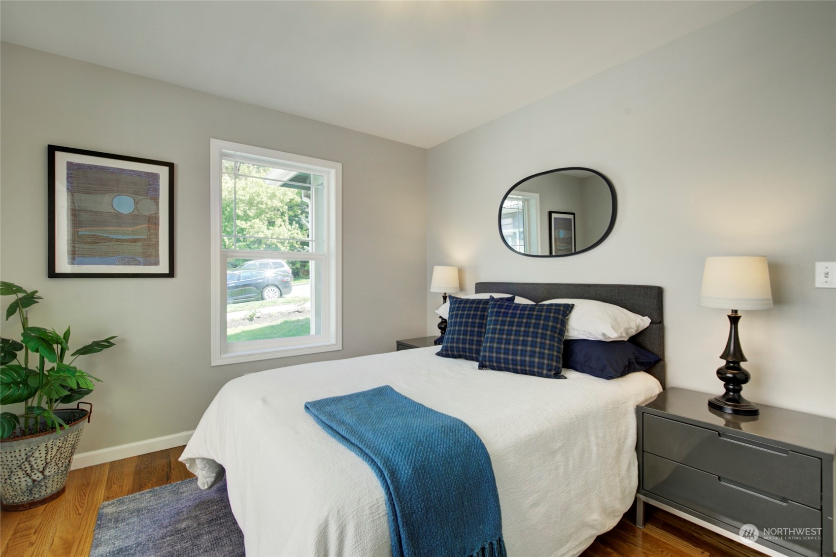 3649 22nd Avenue Southwest Seattle, WA 98106 - Photo 12 of 40 a bedroom with a bed and a potted plant