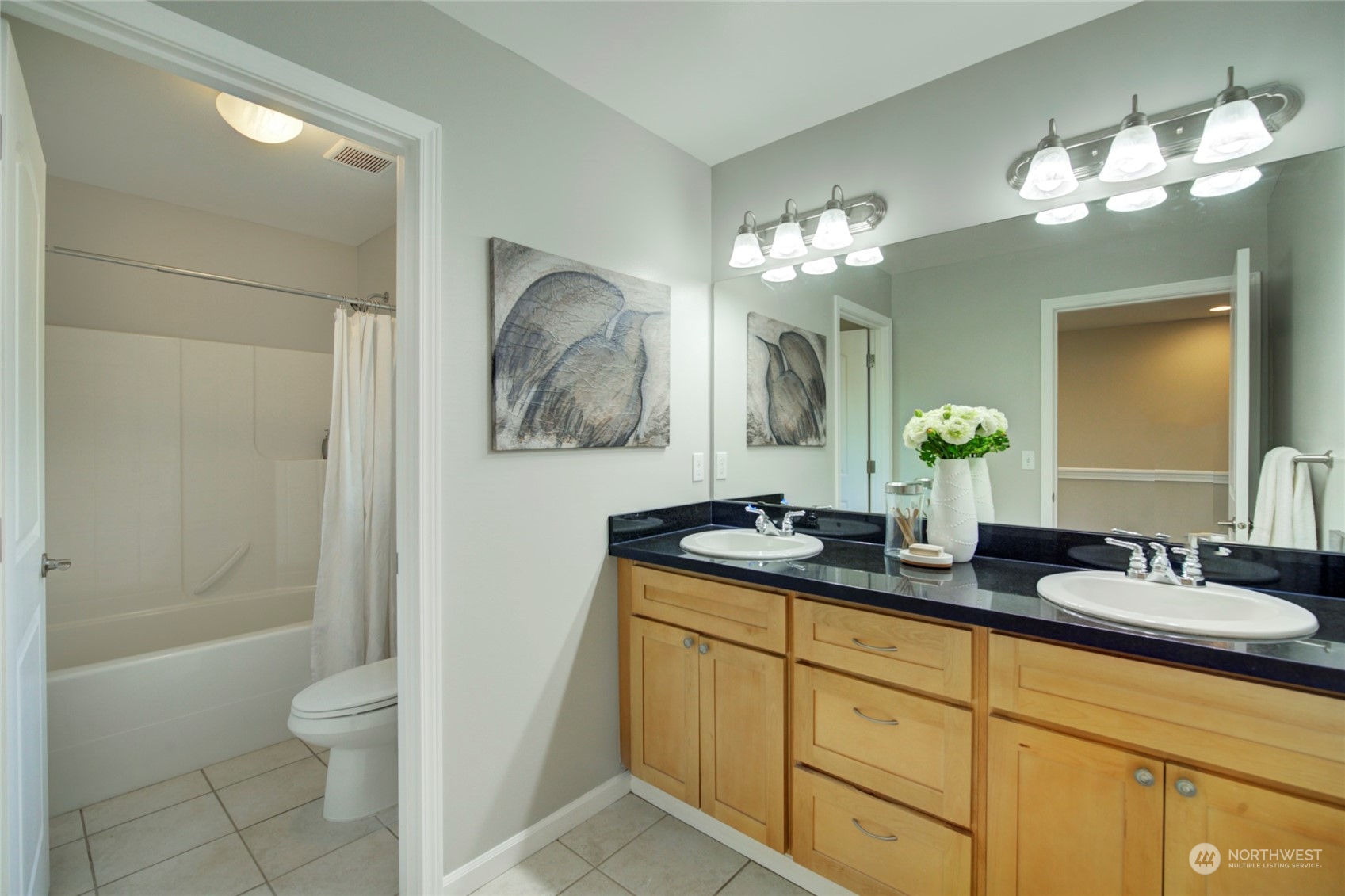 3649 22nd Avenue Southwest Seattle, WA 98106 - Photo 25 of 40 a bathroom with a granite countertop sink a toilet and a mirror