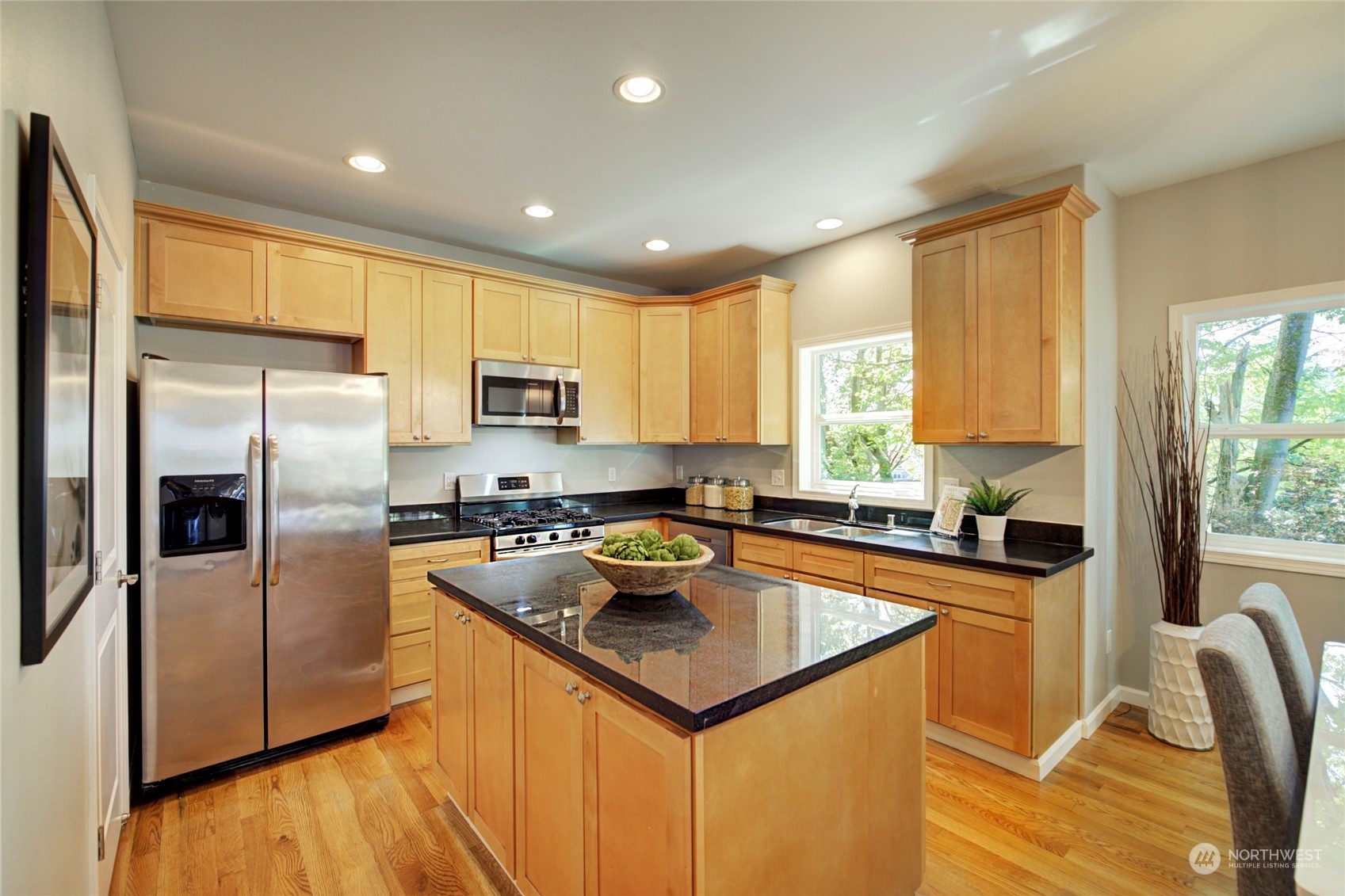 3649 22nd Avenue Southwest Seattle, WA 98106 - Photo 5 of 40 a kitchen with stainless steel appliances granite countertop a sink stove microwave and refrigerator