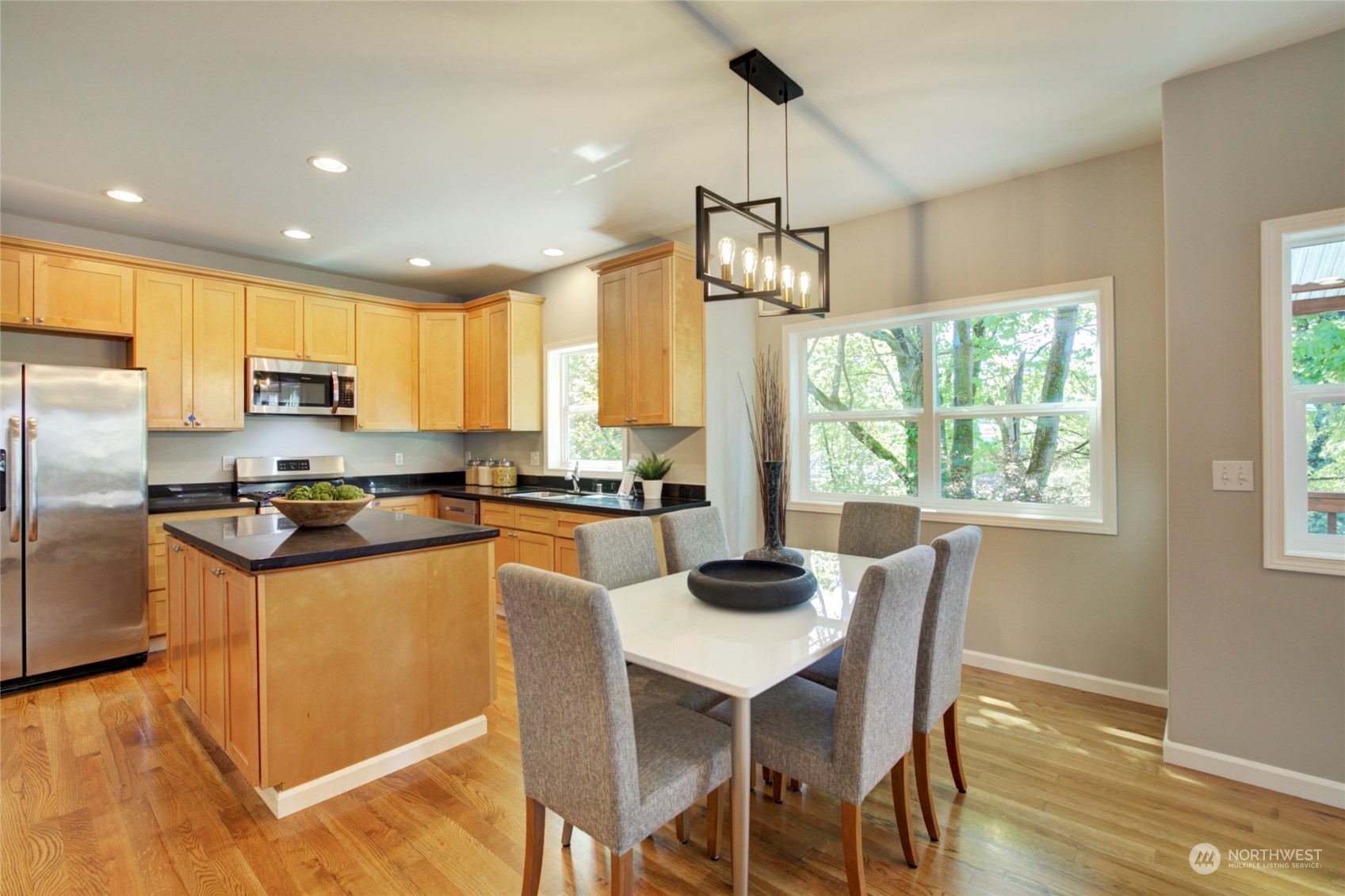 3649 22nd Avenue Southwest Seattle, WA 98106 - Photo 7 of 40 a kitchen with granite countertop a center island stainless steel appliances cabinets and a counter top space