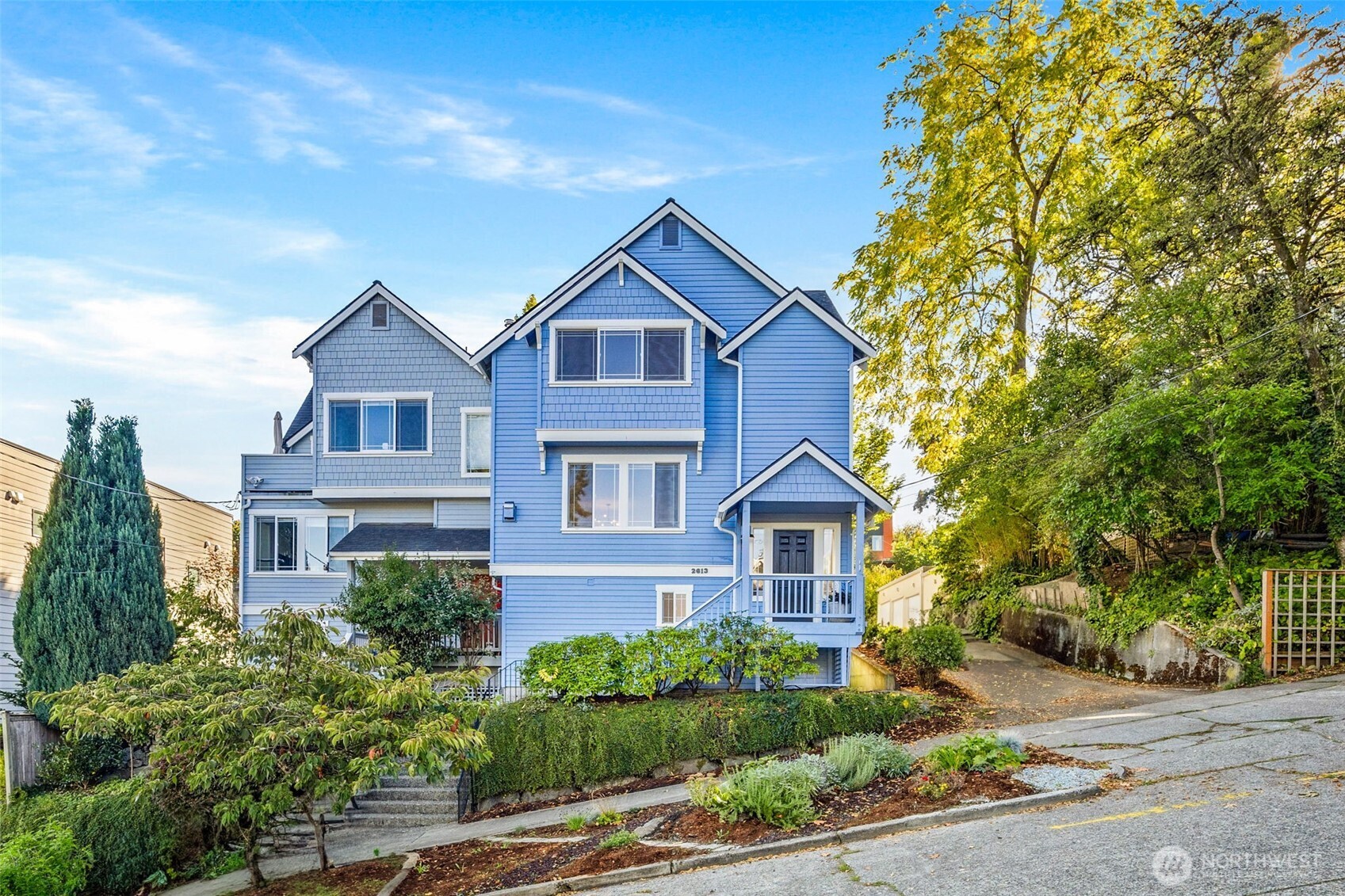 a front view of a house with yard and green space