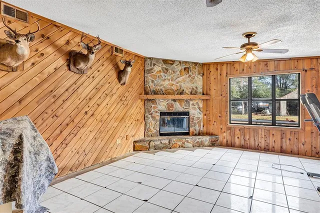 a view of an empty room with a fireplace and a window