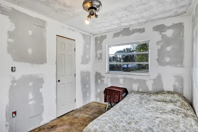 a bedroom with a bed and a window