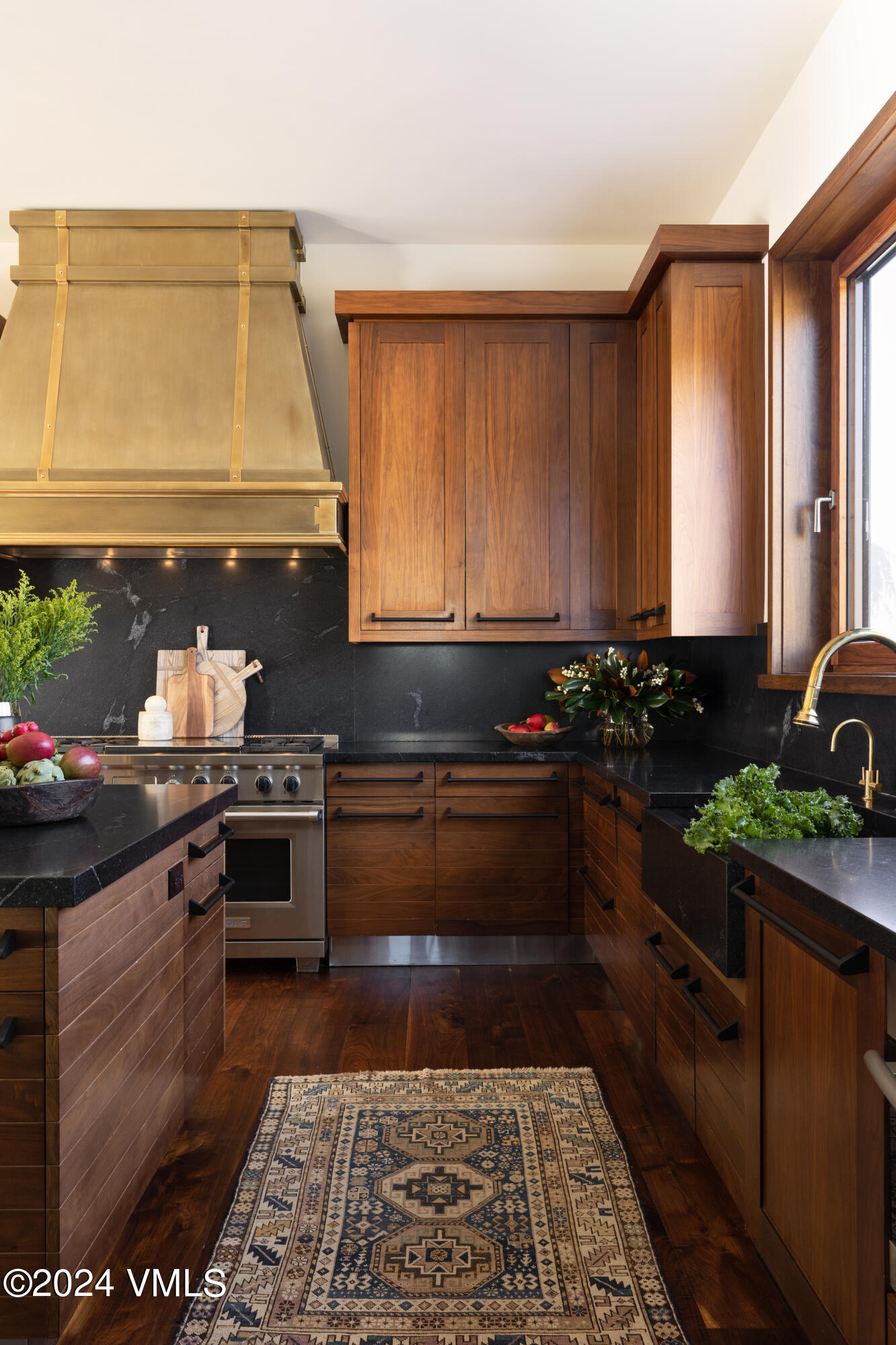 107 Rockledge Road Vail, CO 81657 - Photo 21 of 65 a kitchen with stainless steel appliances granite countertop a stove a sink and a microwave
