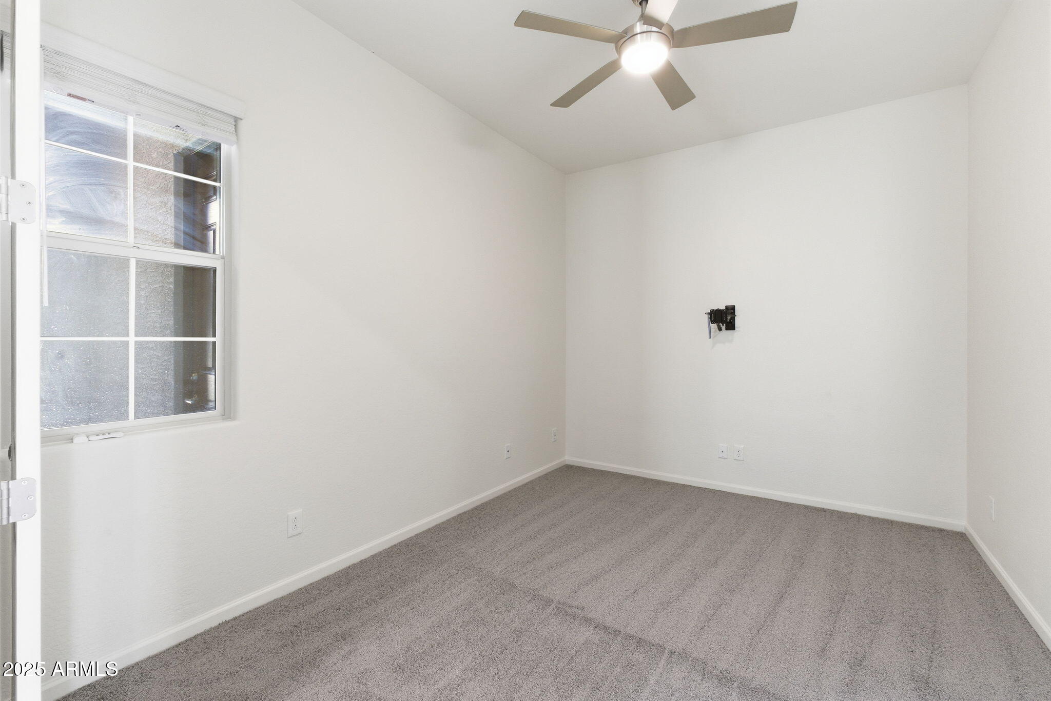 18545 West Chuckwalla Canyon Road Goodyear, AZ 85338 - Photo 19 of 26 an empty room with a empty space and a window