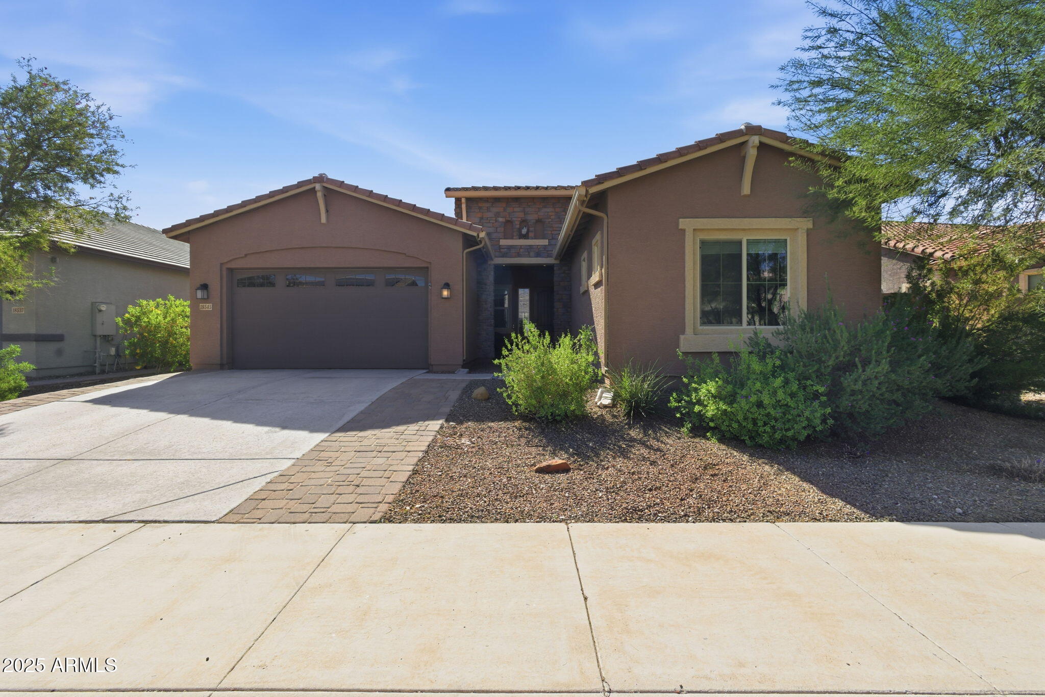 18545 West Chuckwalla Canyon Road Goodyear, AZ 85338 - Photo 2 of 26 a front view of a house with a yard and garage