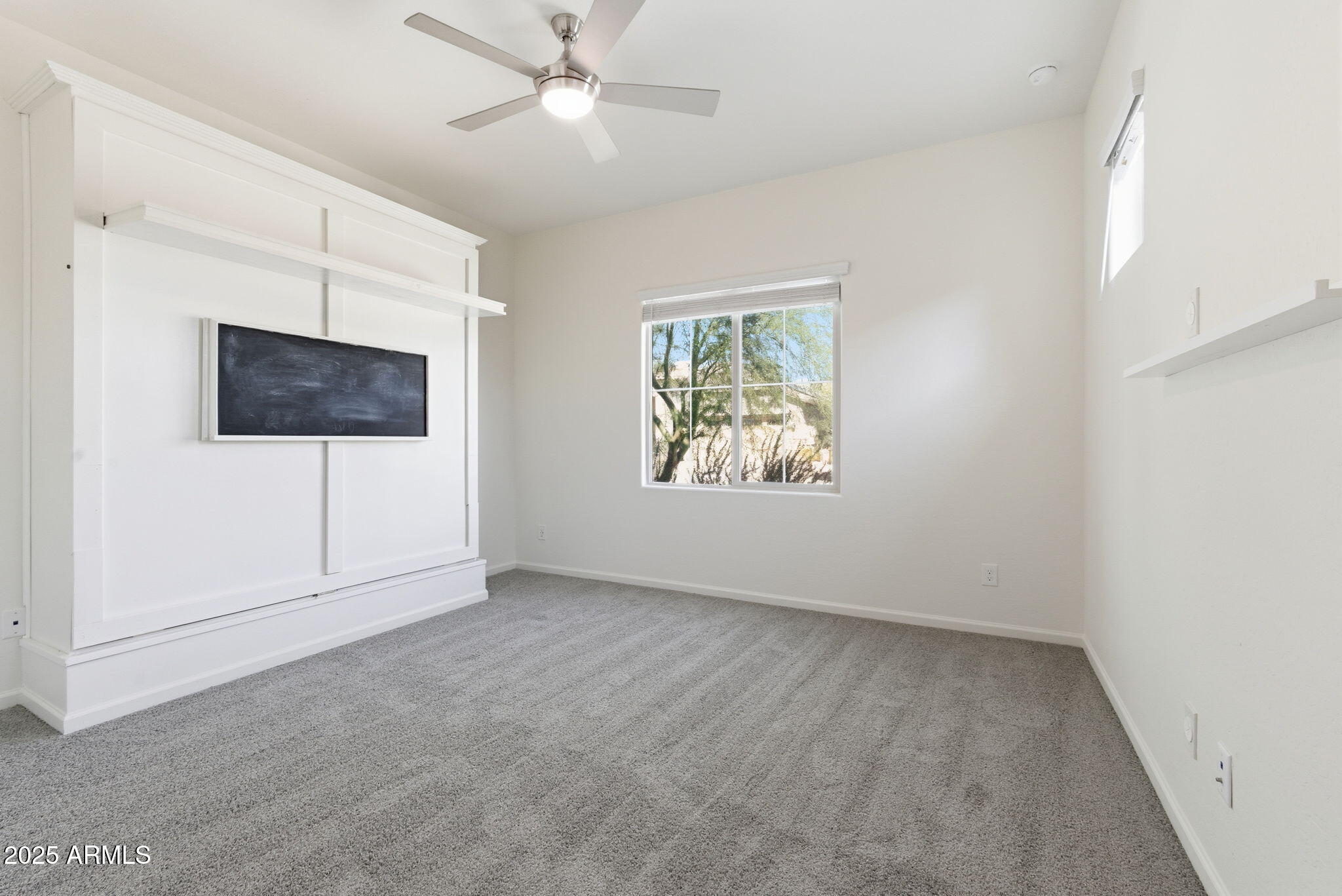 18545 West Chuckwalla Canyon Road Goodyear, AZ 85338 - Photo 22 of 26 an empty room with windows and fan