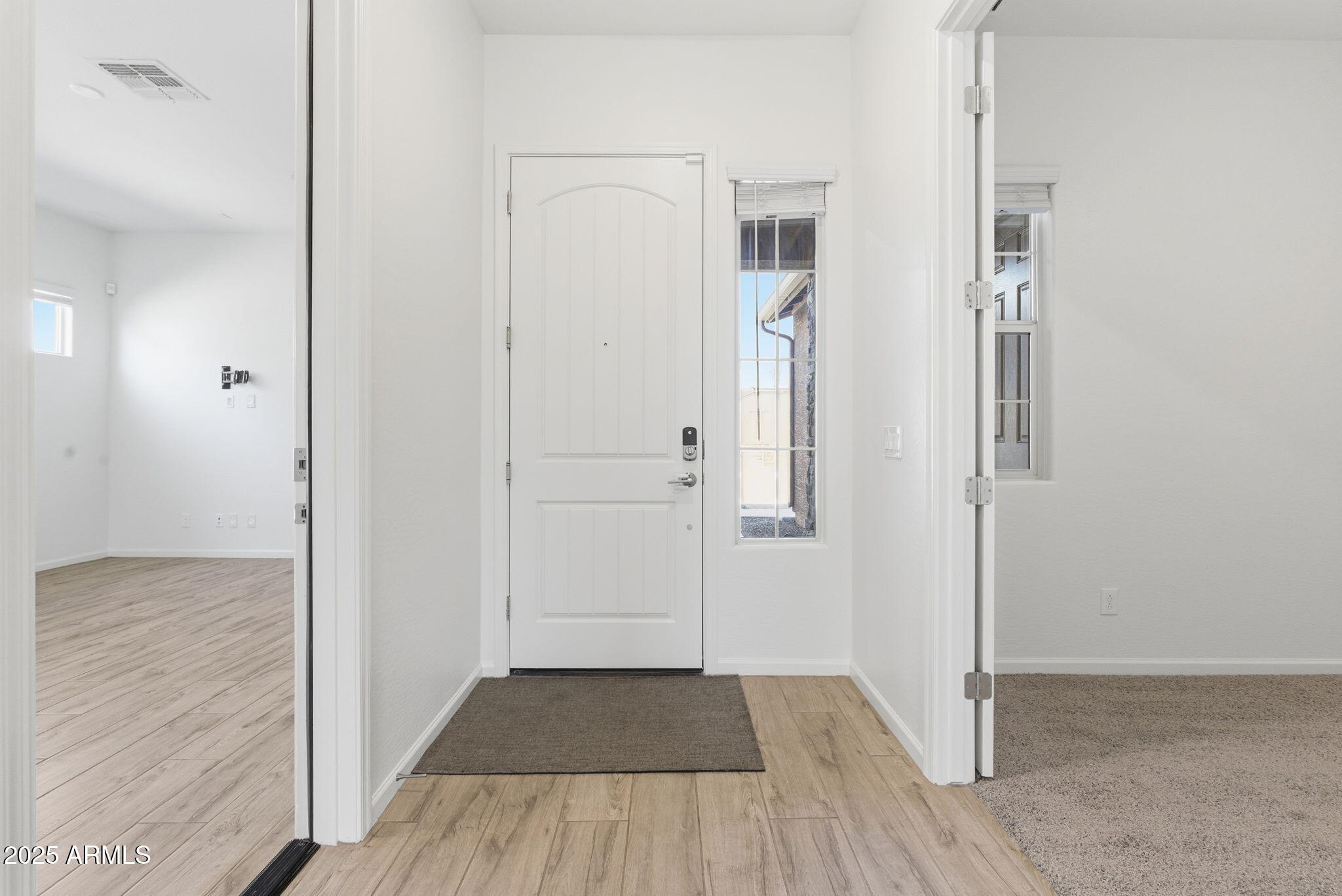 18545 West Chuckwalla Canyon Road Goodyear, AZ 85338 - Photo 4 of 26 an empty room with wooden floor