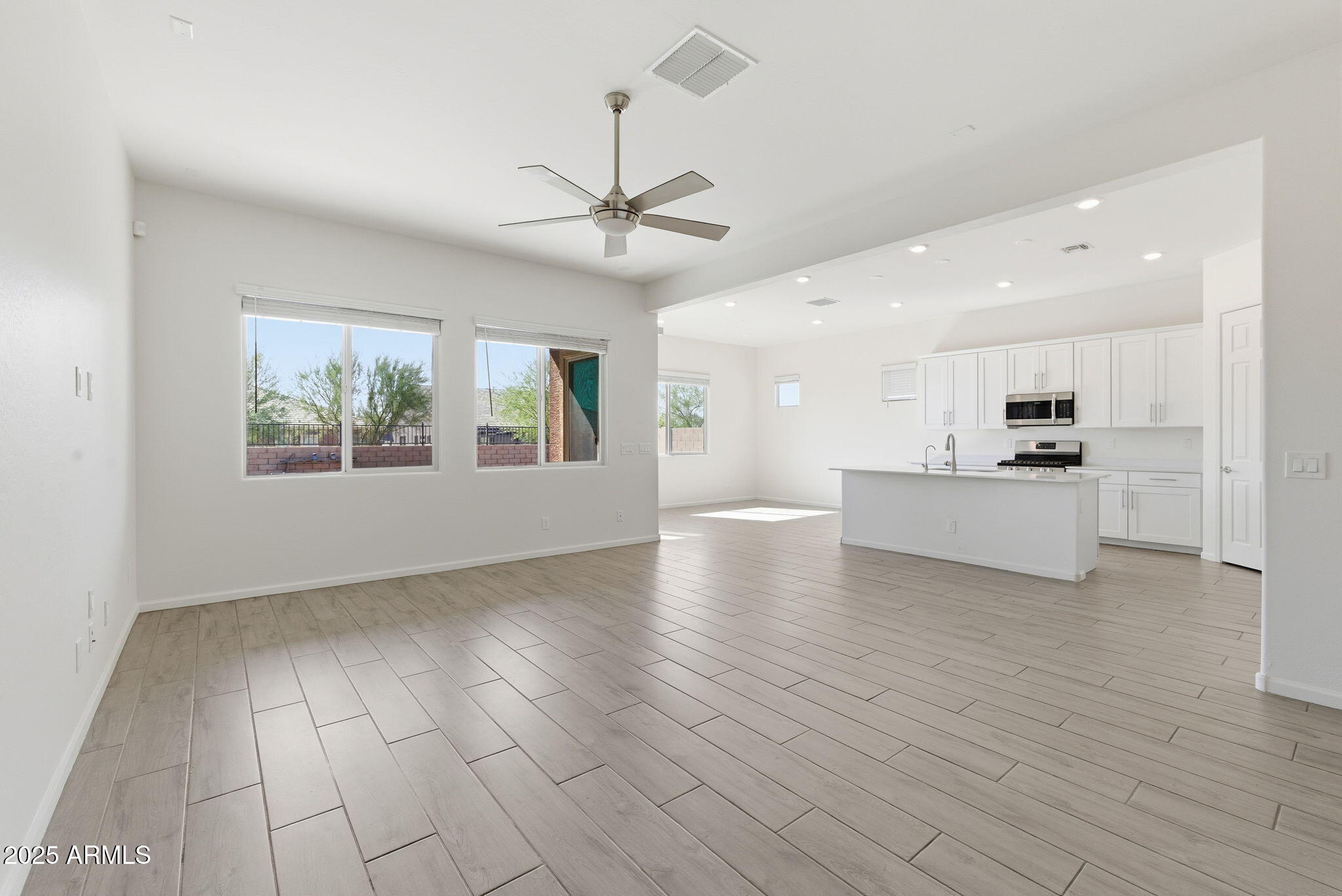 18545 West Chuckwalla Canyon Road Goodyear, AZ 85338 - Photo 10 of 26 a view of an empty room with window and wooden floor
