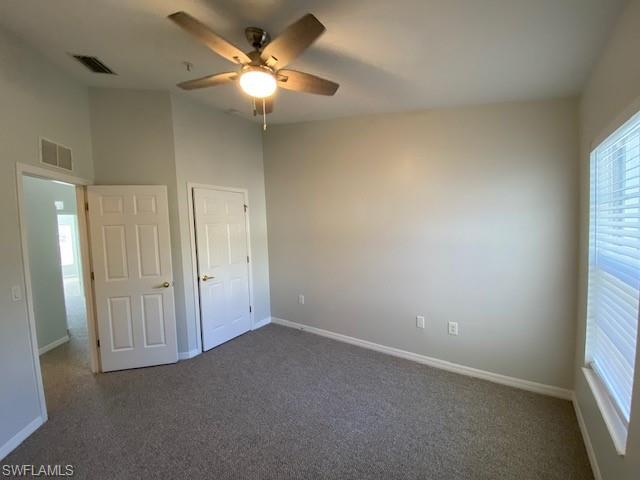 839 Hampton Circle, Unit 149 Naples, FL 34105 - Photo 15 of 32 an empty room with a window and a fan