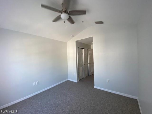 839 Hampton Circle, Unit 149 Naples, FL 34105 - Photo 18 of 32 an empty room with a ceiling fan and carpet
