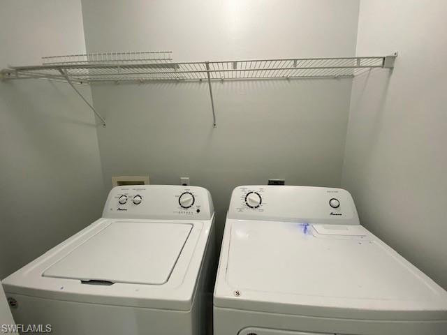 839 Hampton Circle, Unit 149 Naples, FL 34105 - Photo 19 of 32 a utility room with dryer and washer