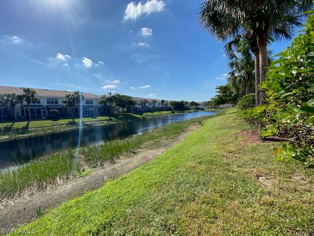 839 Hampton Circle, Unit 149 Naples, FL 34105 - Photo 23 of 32 a view of a lake with houses in the back