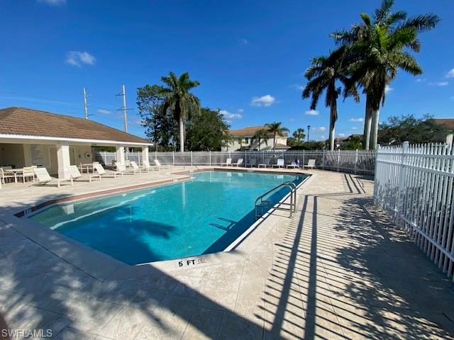 839 Hampton Circle, Unit 149 Naples, FL 34105 - Photo 30 of 32 a view of a swimming pool with a patio