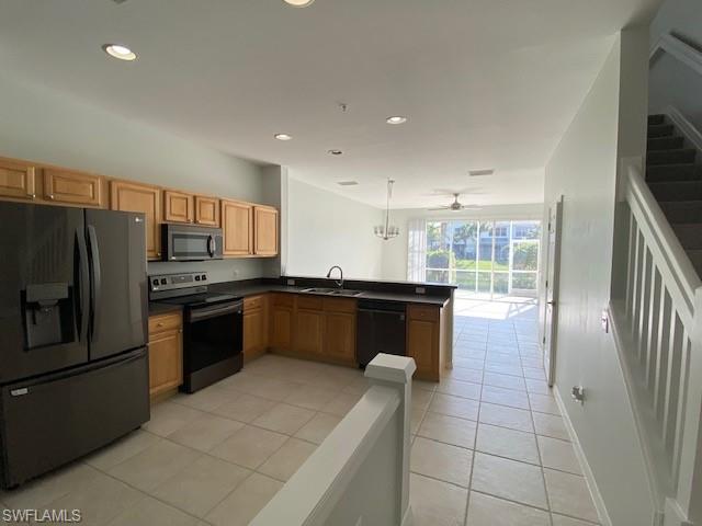 839 Hampton Circle, Unit 149 Naples, FL 34105 - Photo 7 of 32 a kitchen with granite countertop a refrigerator and a stove top oven