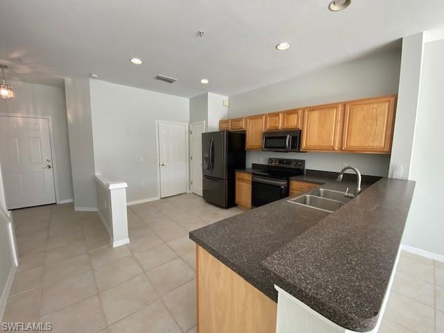 839 Hampton Circle, Unit 149 Naples, FL 34105 - Photo 9 of 32 a kitchen with stainless steel appliances granite countertop a sink stove and refrigerator