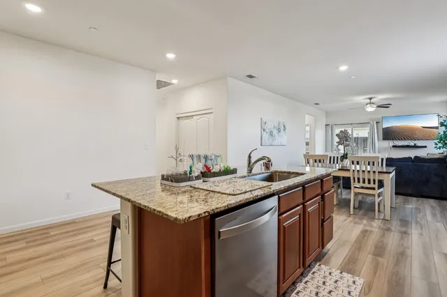 a kitchen with stainless steel appliances granite countertop a sink stove and cabinets