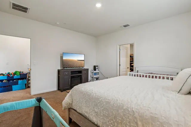 a bedroom with a bed and a flat screen tv