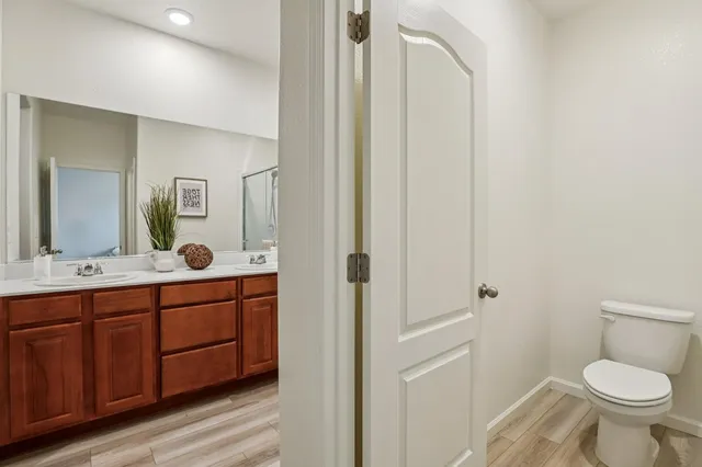 a bathroom with a toilet sink and mirror