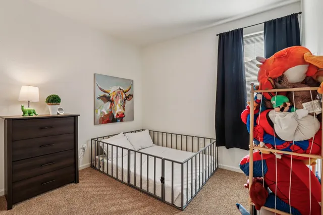 a bedroom with furniture and a baby crib