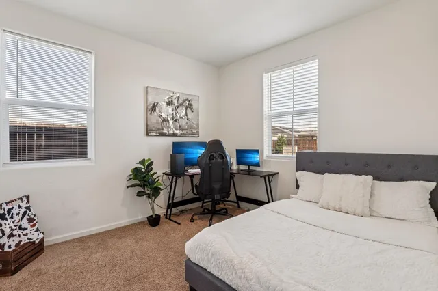 a bedroom with a bed and a desk