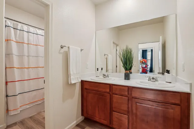 a bathroom with a double vanity sink and mirror