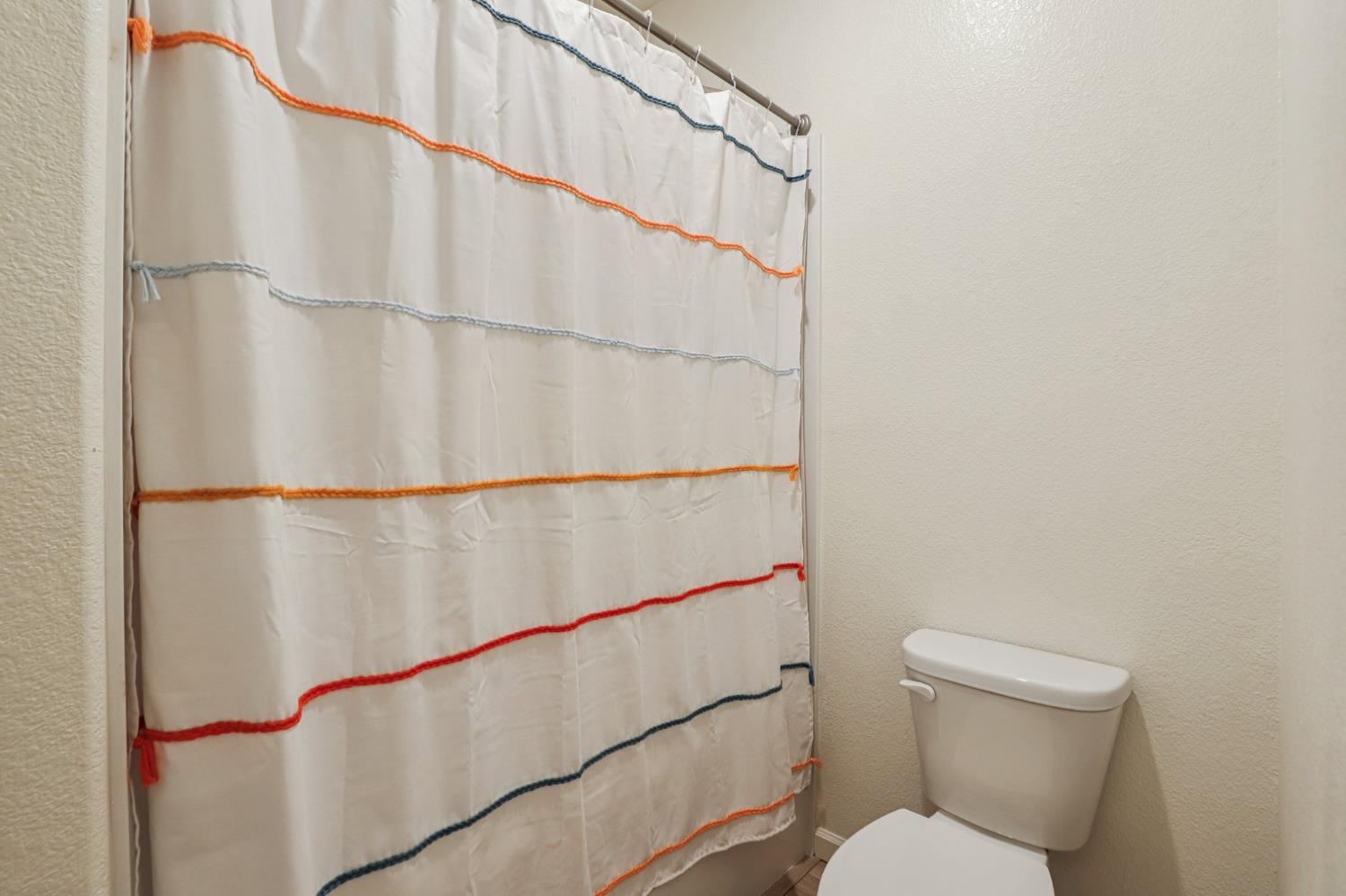 5626 Sunhaven Street Marysville, CA 95901 - Photo 27 of 31 a bathroom with a toilet and a shower curtain